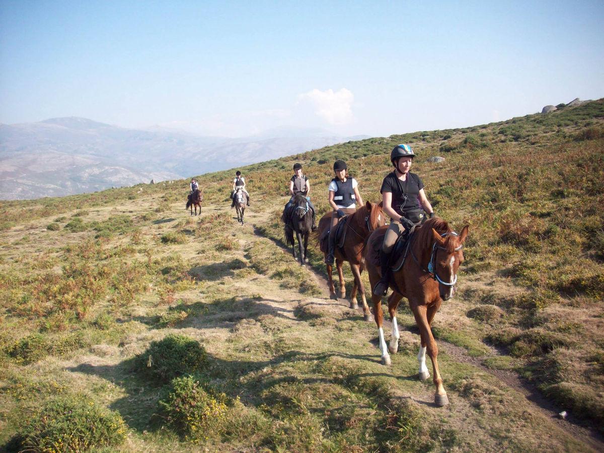 A group of tourists on horseback in the mountains of Portugal